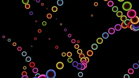 Trails of colored balls on a black background in a seamless loop. Stock Footage 291975903