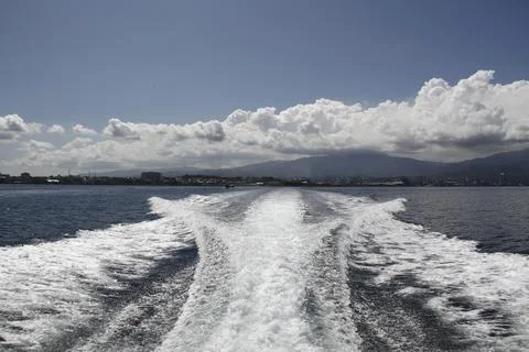 Trails of foam engines when in the blue sea waters and beautiful sky Stock Photos