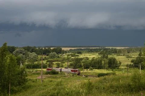 Train and approaching thunderstorm Stock Photos
