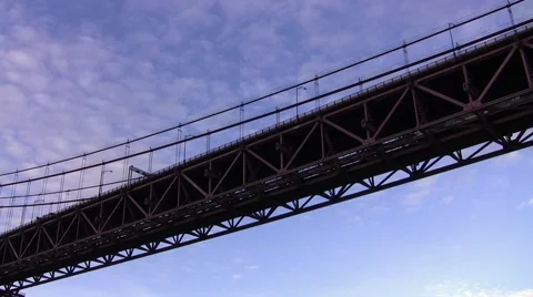 Train and cars using suspended bridge across the river Stock Footage 48527870