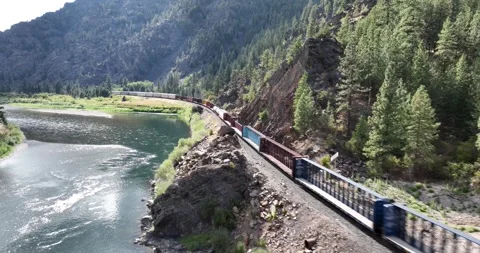 A Train and a River in the Mountains Drone Aerial View Paradise Montana USA Stock-Footage 335706375