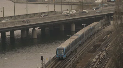 Train and vehicles moving on bridge in Stockholm Stock Footage 65875343