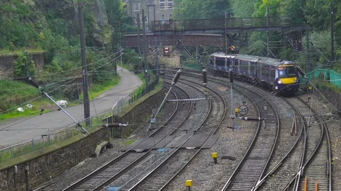 Train Approach and Pass Under, view from above, in Edinburgh Stock Footage 87192923