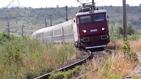 Train approaches a station after a long journey through the hills Stock Footage 60798499