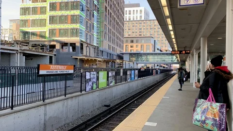Train approaching at Assembly Station, a boston MBTA orange line train statio Stock Footage 128198427