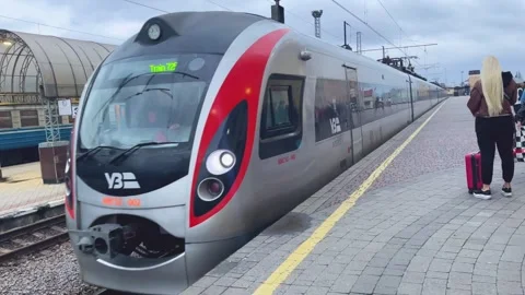 Train approaching a crowded platform at a transport hub Stock-Footage 264104787