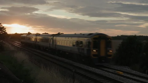 Train approaching in the evening light Stock Footage 221480991