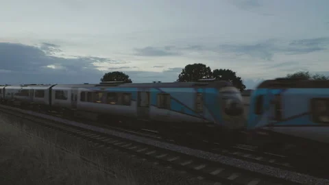 Train approaching in the evening light Stock Footage 221483147