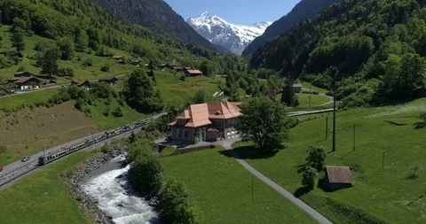 Train approaching Grindelwald - Aerial 4K - Part 1 Stock Footage 89733059