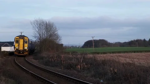 Train approaching level crossing Ayrshire Scotland 動画素材 131732097