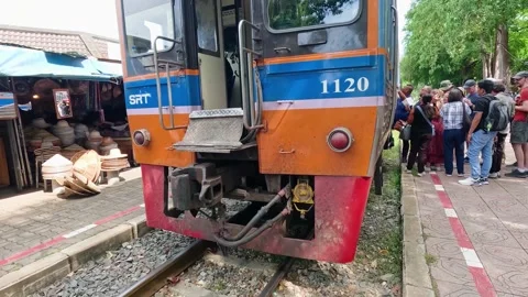 Train Approaching Market Crowd at River Kwai Bridge Stock Footage 313270081