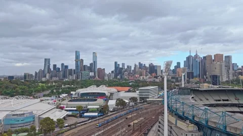 Train Approaching Melbourne CBD with Melbourne Park Aerial View Stock Footage 325820978
