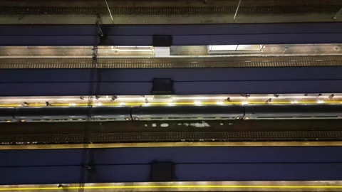 Train approaching platform at night, illuminated by overhead lights Stock Footage 323944419
