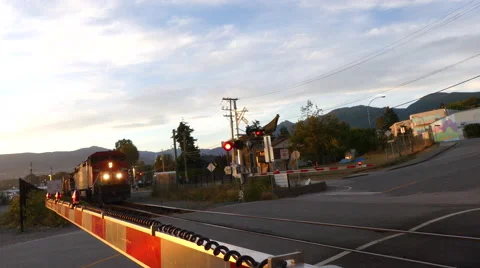 Train approaching red flashing lights Stock Footage 67726163