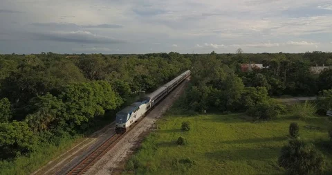 Train approaching on scenic country railway Stock Footage
