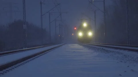 Train approaching on a snowy night Stock Footage 148115348