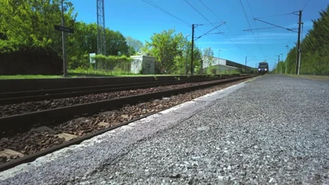 Train approaching station platform as a French regional express nears the stop Video stock 333503214