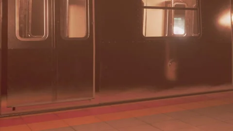 Train approaching a subway platform in a city during evening hours Stock Footage 342801541
