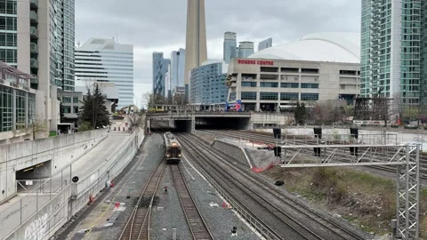 Train approaching in Toronto with CN Tower, Rogers Centre Stock Footage 308332684