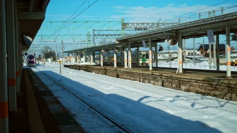 Train arrival station platform with snow in Japan  Stock Footage 100527779