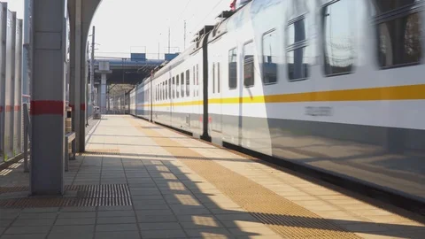 Train arrival on a sunny day to ground railway station Stock Footage 107154199
