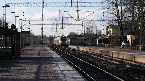 Train Arrives at Empty Platform in Small Town in Sweden, Slow Motion Stock Footage 195413196