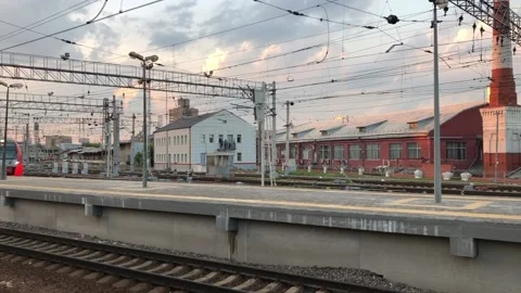 Train arrives to the station at sunset Stock Footage 132314374