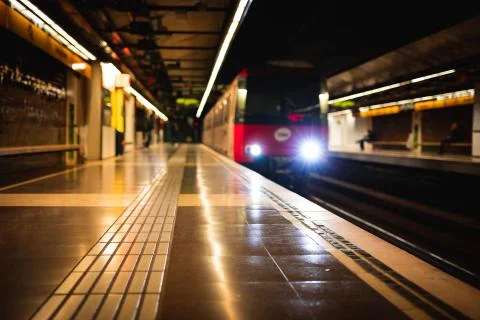 Train arriving at an empty subway train station blurred Stock Photos
