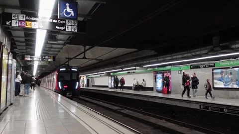 Train arriving at a metro station platform in Barcelona Stock Footage 294999679