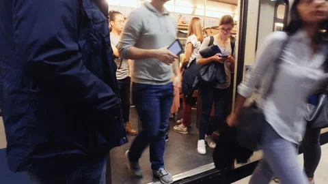 Train arriving on the platform, crowd of people going in and out of the train Stock Footage 135275064