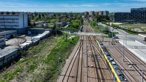 Train arriving a railroad level crossing in Krakow, Poland Stock Footage 303554087