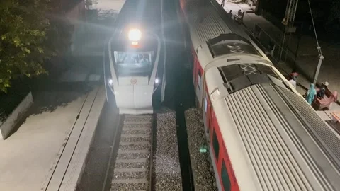 Train arriving at station at night from overbridge view Vídeos de archivo 332920893