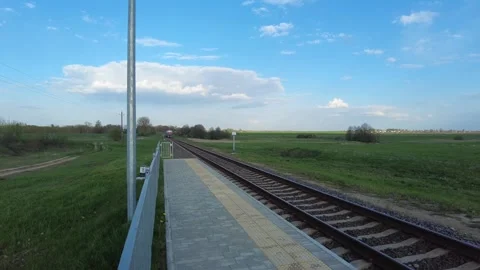 Train arriving at stops on a summer evening Stock Footage 252054388