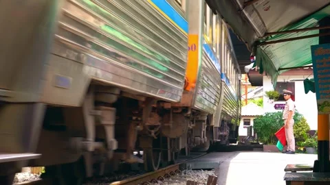 Train Arriving at Talat Phlu Station with Signal Guard - Bangkok 4K Stock Footage 345577882