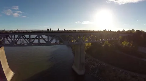 Train bridge across a river with people silhouettes 動画素材 43315428
