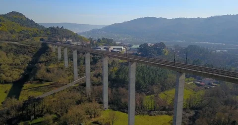 TRAIN BRIDGE IN A GREEN VALLEY WITH FACTORIES, HOUSES AND THE CITY OF OURENSE Stock Footage 103288595