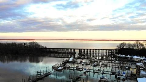 Train Bridge over River and Marina in Winter at sunset 動画素材 104011283