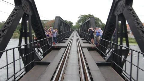 Train on the bridge over the river Kwai in Kanchanaburi, Thailand Stock Footage 102658371