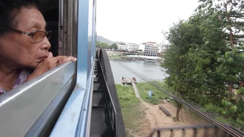 Train on the bridge over the river Kwai in Kanchanaburi, Thailand Stock Footage 102666759