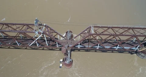 Train bridge supports from above over large fast flowing river drone aerial 4K Stock Footage 111363546