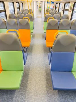 Train car inside view with bright multi-colored seats Stock Photos