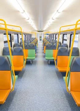 Train car inside view with bright multi-colored seats Stock Photos