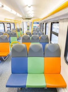 Train car inside view with bright multi-colored seats Stock Photos