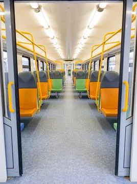 Train car inside view with bright multi-colored seats Stock Photos