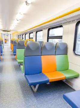 Train car inside view with bright multi-colored seats Stock Photos