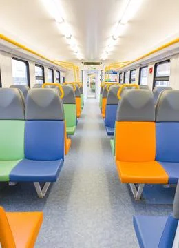 Train car inside view with bright multi-colored seats Stock Photos