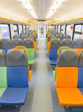 Train car inside view with bright multi-colored seats Stock Photos