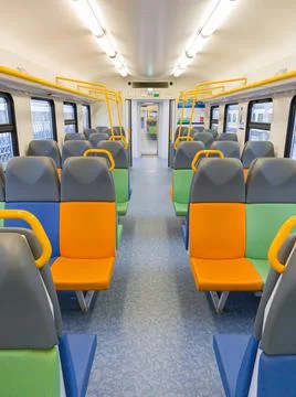 Train car inside view with bright multi-colored seats Stock Photos