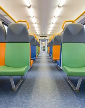 Train car inside view with bright multi-colored seats Foto stock