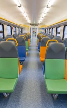 Train car inside view with bright multi-colored seats Stock Photos